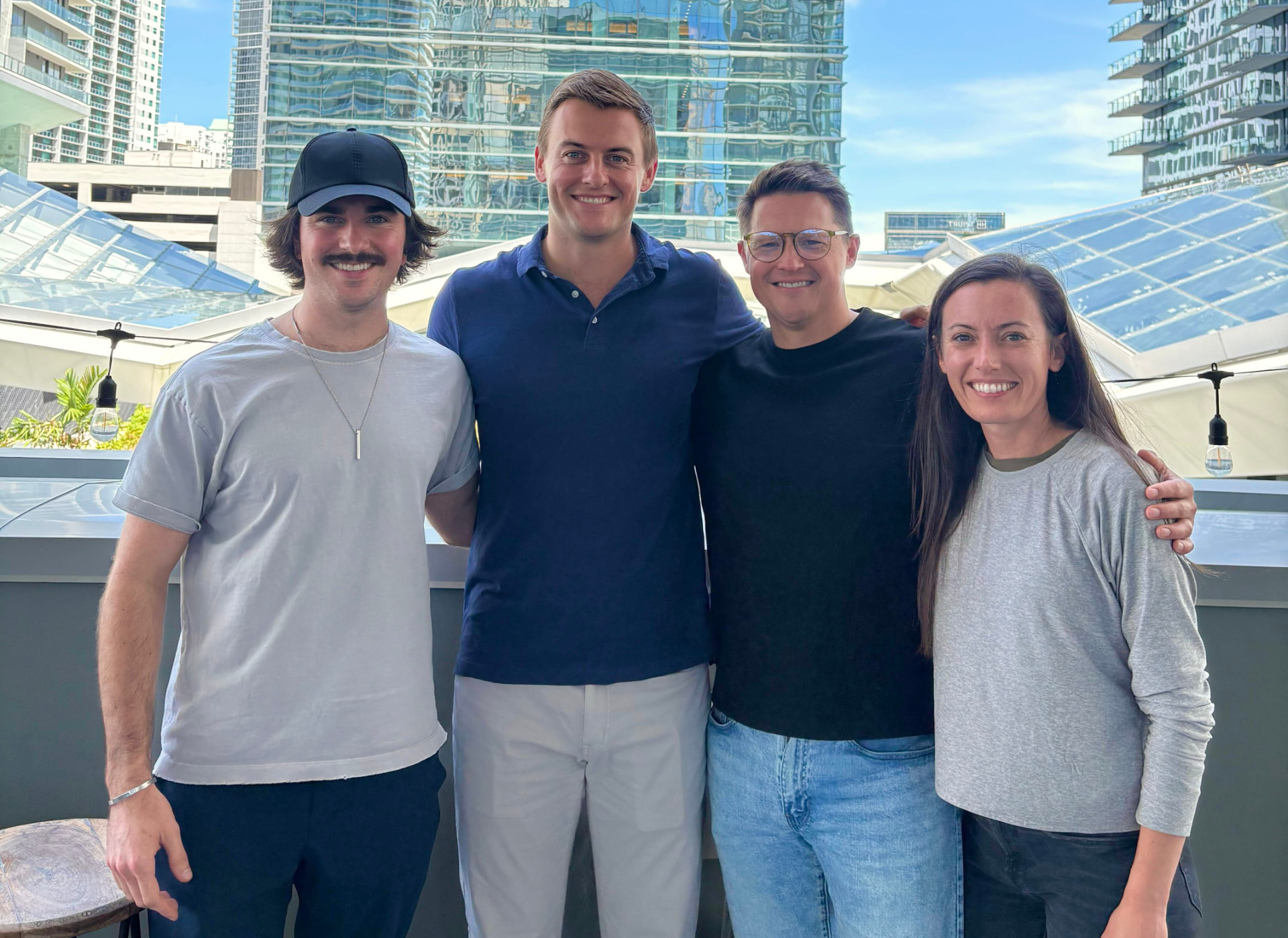 Four Cyclops team members together on a sunny city terrace